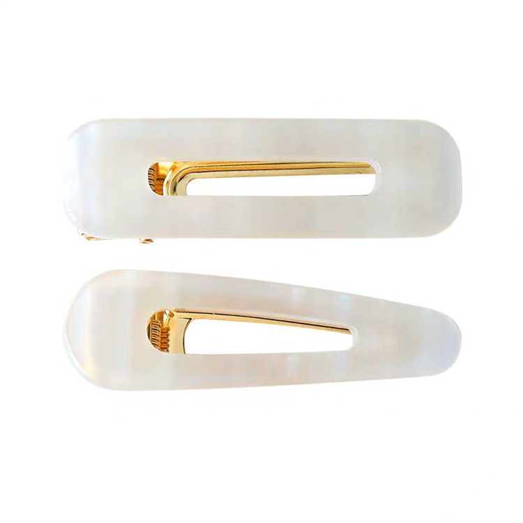 A pair of white acetate board hairpins